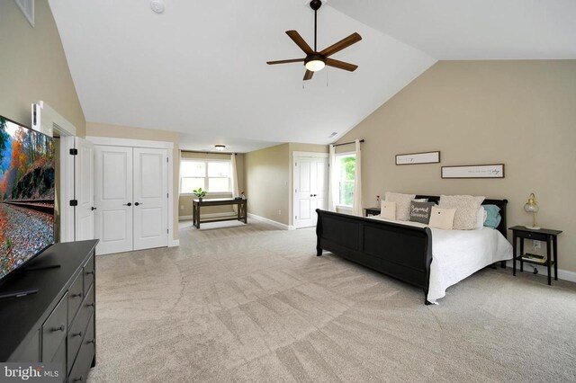  - bedroom with baseboards, light colored carpet, high vaulted ceiling, and a ceiling fan
