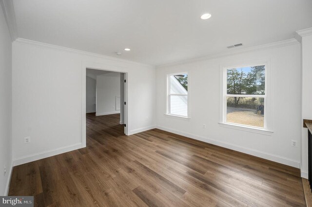  - empty room with crown molding, baseboards, wood finished floors, and recessed lighting