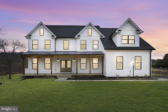  - modern farmhouse featuring french doors, covered porch, a front yard, and a standing seam roof