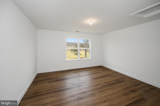  - unfurnished room featuring dark wood-style flooring and baseboards