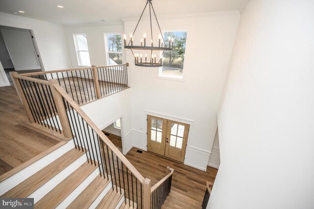  - foyer featuring wood finished floors, a chandelier, ornamental molding, french doors, and recessed lighting