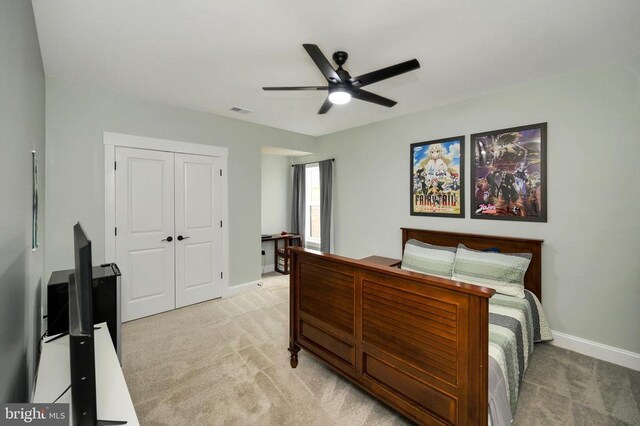  - bedroom featuring light carpet, baseboards, and a closet