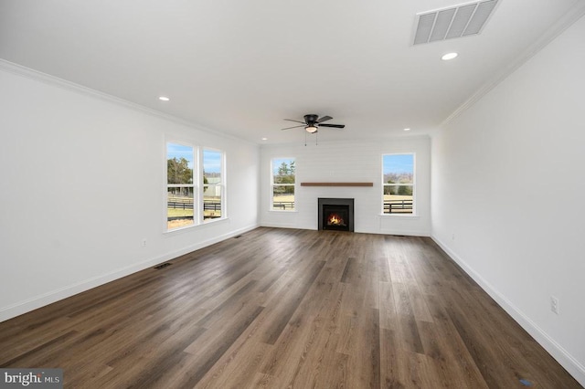  - unfurnished living room featuring a ceiling fan, crown molding, dark wood-type flooring, a large fireplace, and baseboards