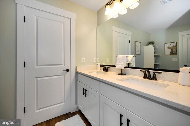  - bathroom with double vanity and wood finished floors