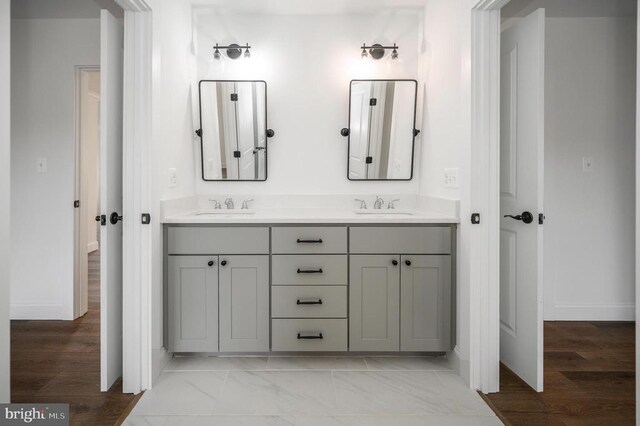  - full bath featuring double vanity and baseboards