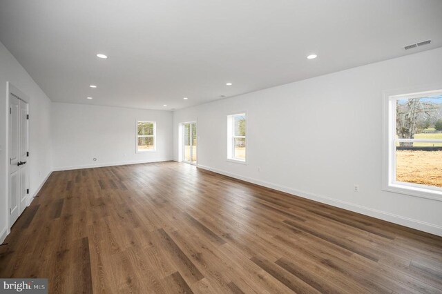  - unfurnished room featuring wood finished floors, recessed lighting, and baseboards