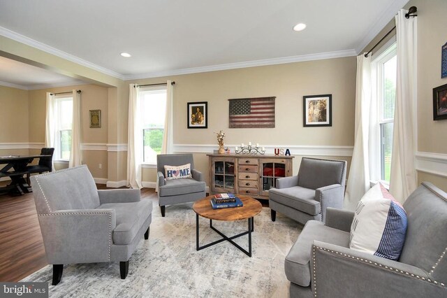  - living area with wood finished floors, ornamental molding, and recessed lighting