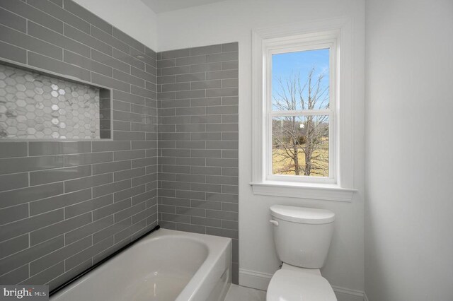  - bathroom featuring baseboards and toilet
