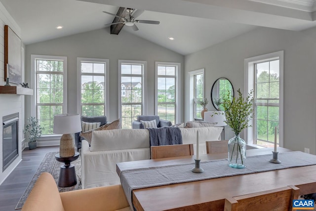 dining room featuring recessed lighting, ceiling fan, vaulted ceiling with beams, wood finished floors, and a large fireplace