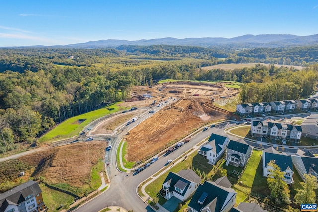 bird's eye view featuring a residential view, a wooded view, and a mountain view