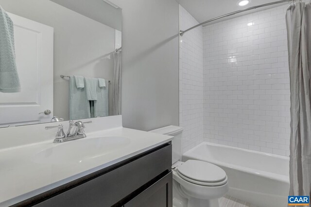 full bath with toilet, shower / tub combo with curtain, vanity, and recessed lighting