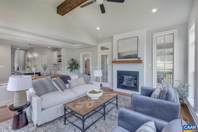 living room featuring beamed ceiling, recessed lighting, ceiling fan, and wood finished floors