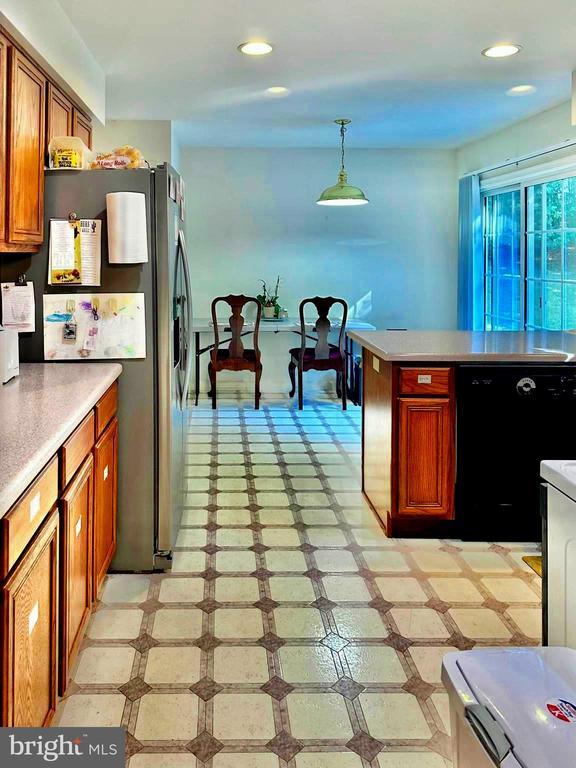 26 Magnolia Ct, Barboursville, VA 22923 - kitchen with stainless steel fridge with ice dispenser, light flooring, brown cabinetry, light countertops, and recessed lighting