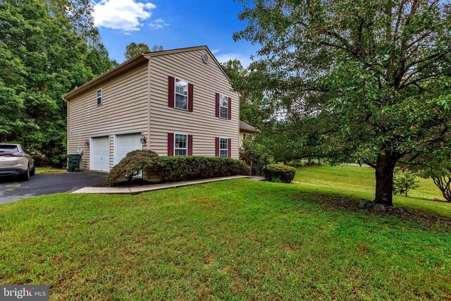 26 Magnolia Ct, Barboursville, VA 22923 - view of side of property with driveway, an attached garage, and a lawn