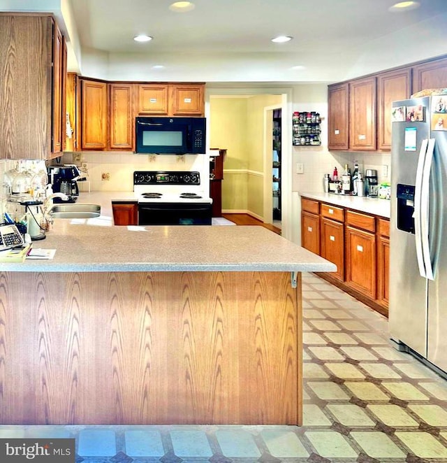 26 Magnolia Ct, Barboursville, VA 22923 - kitchen featuring stainless steel refrigerator with ice dispenser, black microwave, range with electric stovetop, a peninsula, and light countertops
