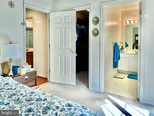 26 Magnolia Ct, Barboursville, VA 22923 - bedroom with a spacious closet, ensuite bathroom, light carpet, and a closet