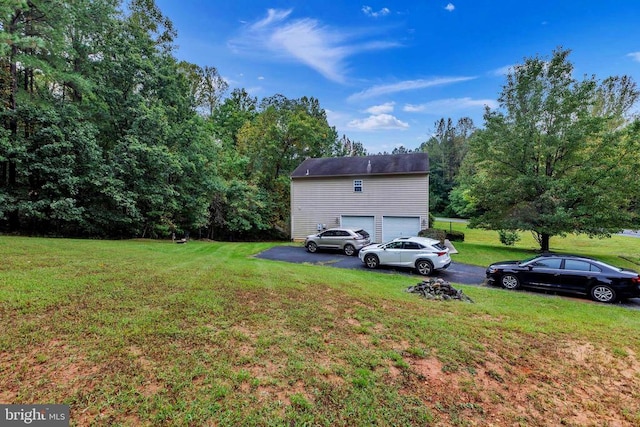 26 Magnolia Ct, Barboursville, VA 22923 - view of grassy yard featuring driveway and a garage