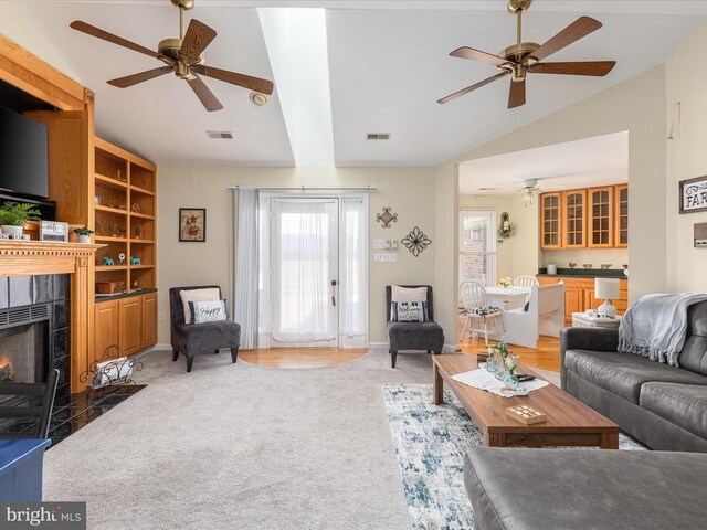 237 Preston Ln, Luray, VA 22835 - living area featuring ceiling fan, vaulted ceiling, light carpet, a fireplace, and baseboards