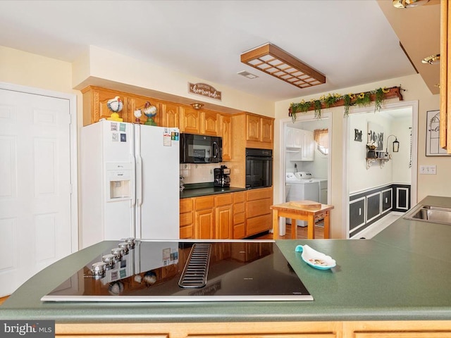 237 Preston Ln, Luray, VA 22835 - kitchen featuring black appliances, washer and clothes dryer, tasteful backsplash, and a sink
