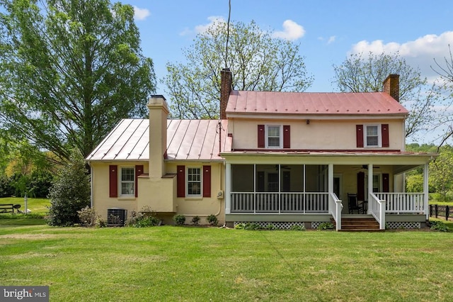  - view of front of house with ceiling fan, a chimney, stucco siding, and a standing seam roof