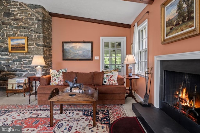  - carpeted living area featuring a large fireplace and baseboards