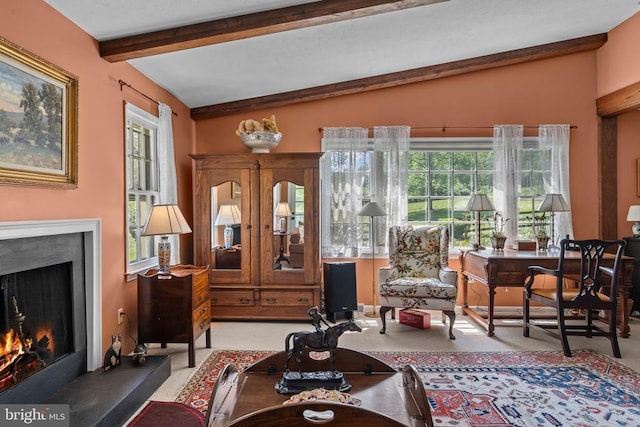  - carpeted living room featuring a warm lit fireplace