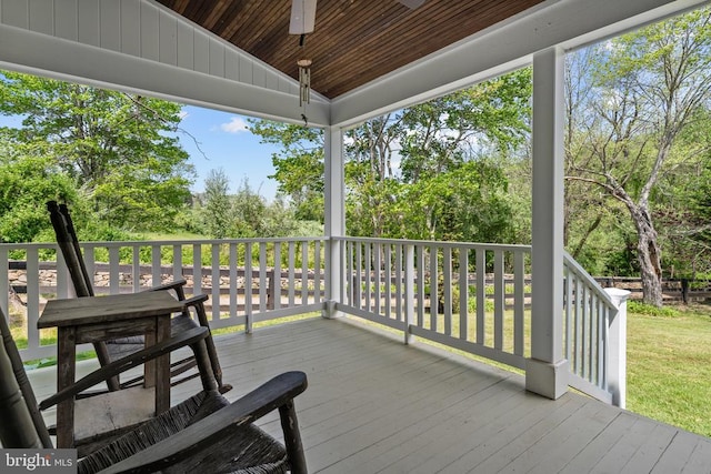  - wooden terrace with ceiling fan and view of scattered trees