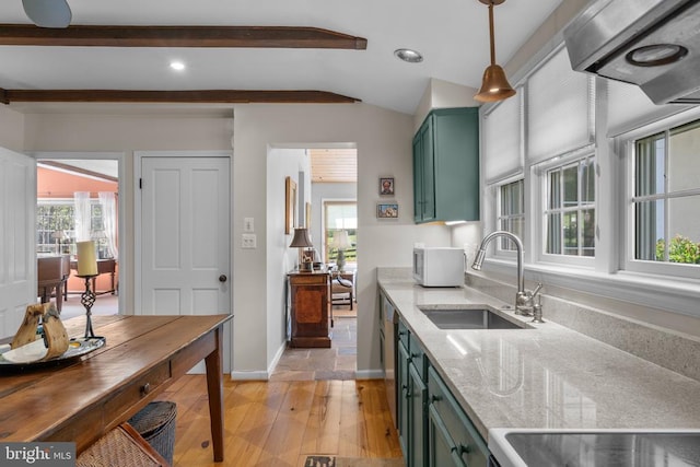  - kitchen featuring green cabinets, a sink, light wood finished floors, light stone counters, and baseboards