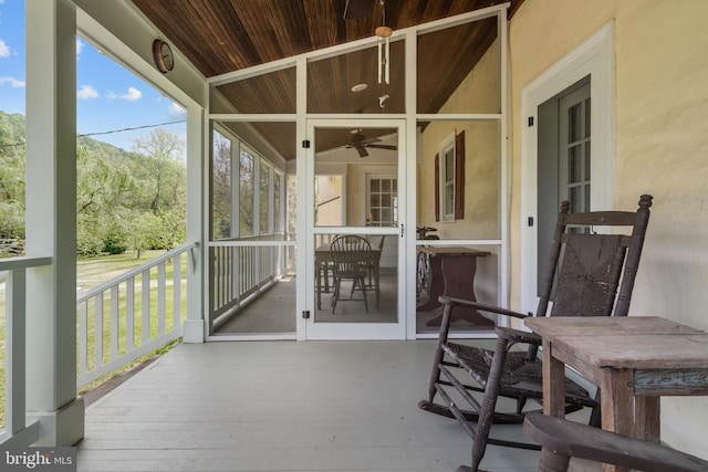  - sunroom / solarium with a ceiling fan