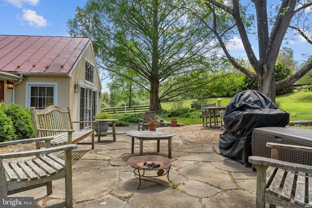  - view of patio with an outdoor fire pit