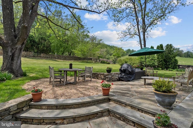  - view of patio with a grill and outdoor dining space