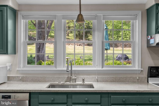  - kitchen featuring green cabinets, a sink, and stainless steel dishwasher