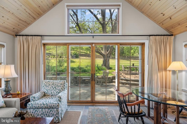  - doorway to outside with wooden ceiling, high vaulted ceiling, and stone tile flooring