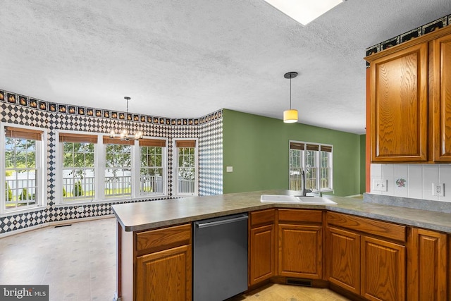 2703 Schumann St, Fredericksburg, VA 22408 - kitchen with stainless steel dishwasher, a textured ceiling, brown cabinets, a peninsula, and decorative light fixtures