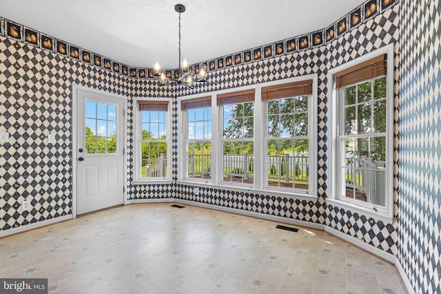 2703 Schumann St, Fredericksburg, VA 22408 - unfurnished dining area featuring wallpapered walls, a chandelier, and plenty of natural light