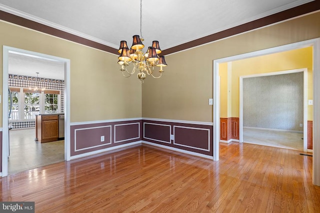2703 Schumann St, Fredericksburg, VA 22408 - spare room with a chandelier, wood finished floors, ornamental molding, and a wainscoted wall