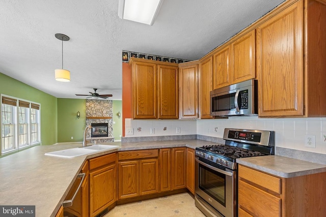 2703 Schumann St, Fredericksburg, VA 22408 - kitchen with stainless steel appliances, ceiling fan, tasteful backsplash, brown cabinetry, and a textured ceiling