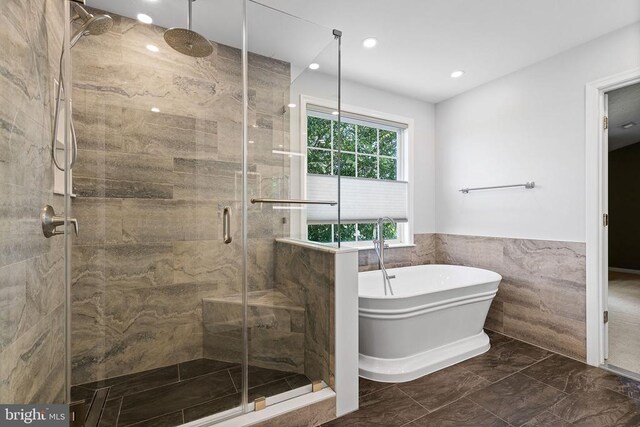 2703 Schumann St, Fredericksburg, VA 22408 - full bathroom with marble tiled flooring, a shower stall, a soaking tub, tile walls, and recessed lighting