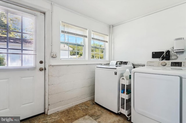 3200 Lafayette Blvd, Fredericksburg, VA 22408 - laundry room featuring independent washer and dryer, plenty of natural light, stone finish floors, and concrete block wall