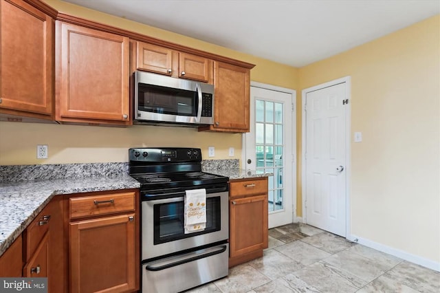 3200 Lafayette Blvd, Fredericksburg, VA 22408 - kitchen featuring appliances with stainless steel finishes, brown cabinets, and light stone countertops