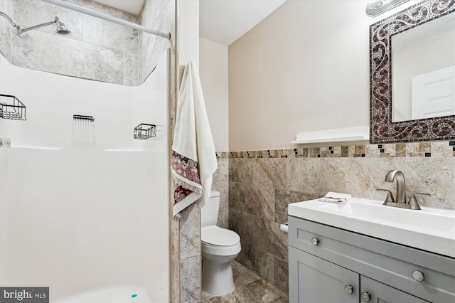 3200 Lafayette Blvd, Fredericksburg, VA 22408 - bathroom featuring a shower stall, tile walls, vanity, and a wainscoted wall