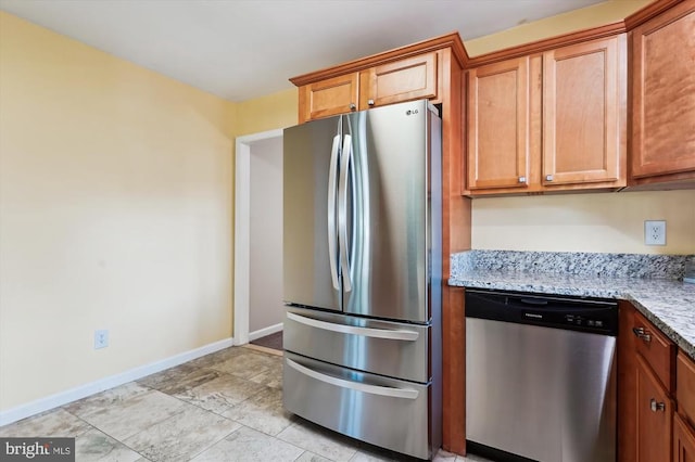 3200 Lafayette Blvd, Fredericksburg, VA 22408 - kitchen featuring appliances with stainless steel finishes, light stone countertops, and brown cabinets