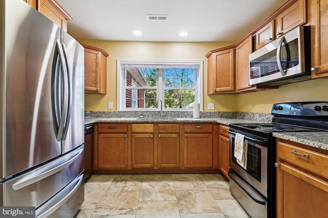 3200 Lafayette Blvd, Fredericksburg, VA 22408 - kitchen with appliances with stainless steel finishes, brown cabinets, light stone countertops, and recessed lighting