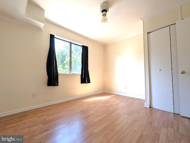 2104 Jefferson Park Ave Unit D, Charlottesville, VA 22903 - unfurnished bedroom with light wood-type flooring, ornamental molding, and a closet