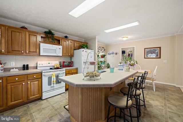 731 Bluewater Blvd S, Mineral, VA 23117 - kitchen featuring a breakfast bar area, brown cabinets, ornamental molding, and white appliances