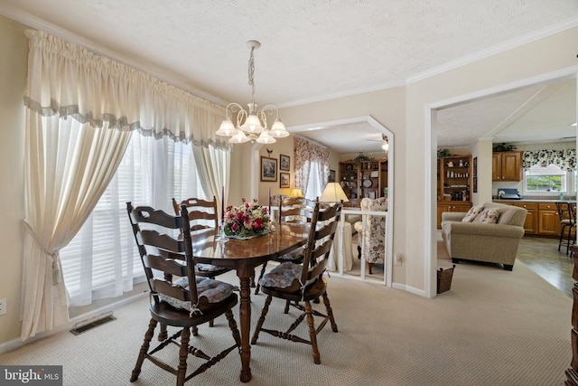731 Bluewater Blvd S, Mineral, VA 23117 - dining area featuring a chandelier, ornamental molding, light colored carpet, and visible vents
