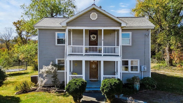 view of front of home featuring a balcony, a trampoline, and covered porch