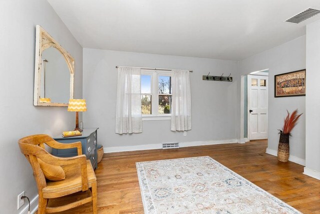 sitting room with hardwood / wood-style flooring