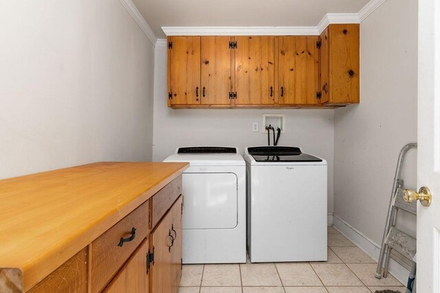 laundry room with separate washer and dryer, light tile patterned floors, crown molding, and cabinets