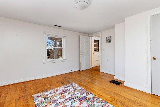 empty room featuring hardwood / wood-style flooring